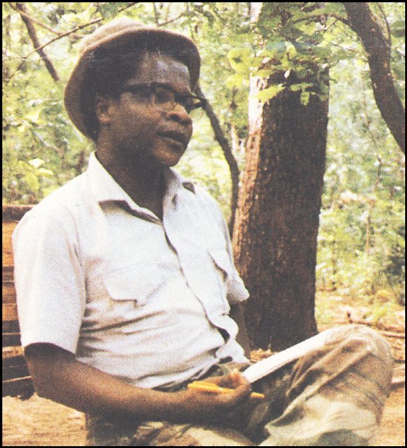 Afonso Dhlakama in civilian clothes, on a bench